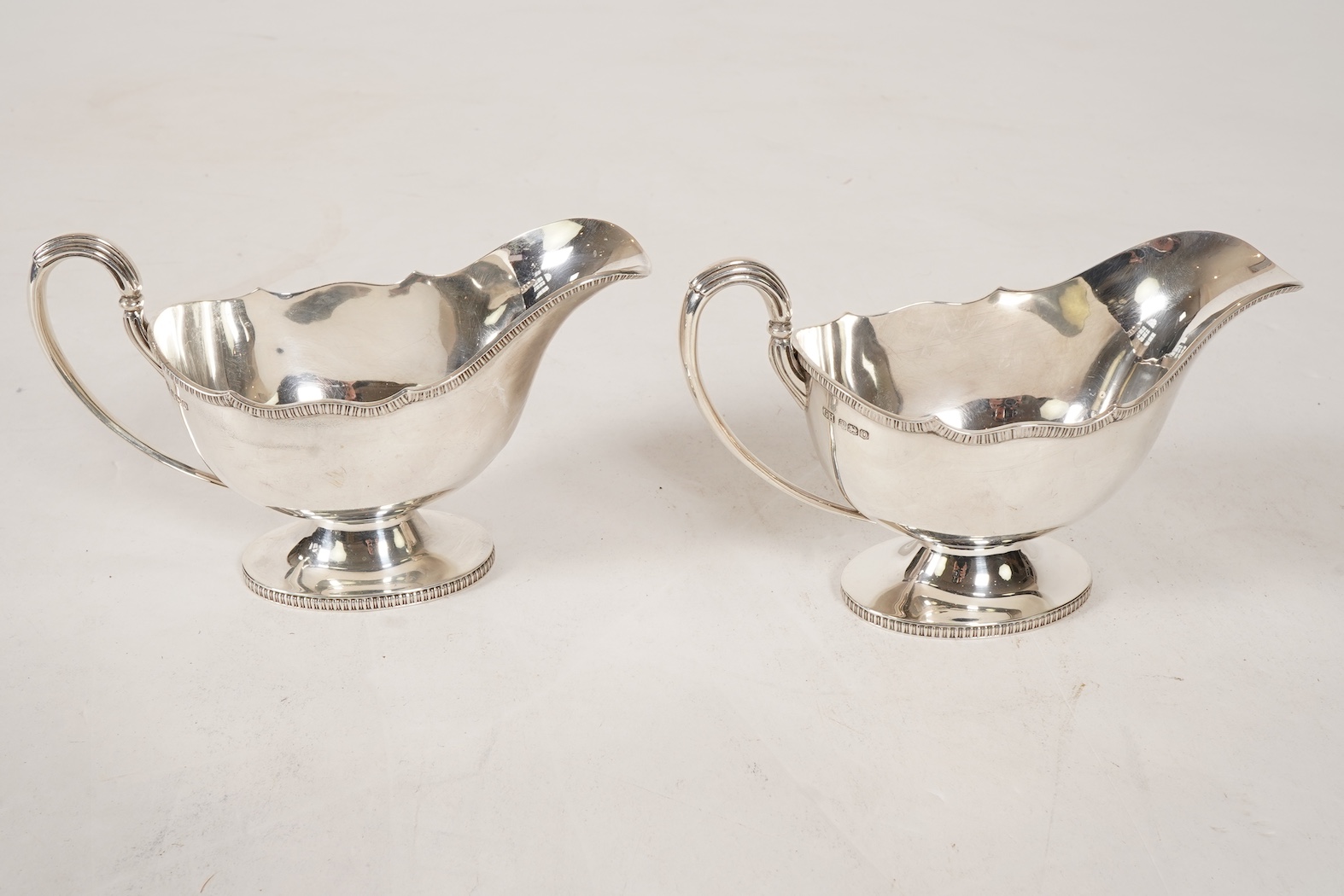 A pair of George V silver pedestal sauce boats, by Howson Brothers